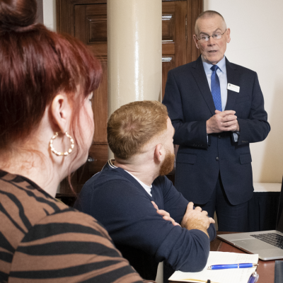 a person presenting to two other people