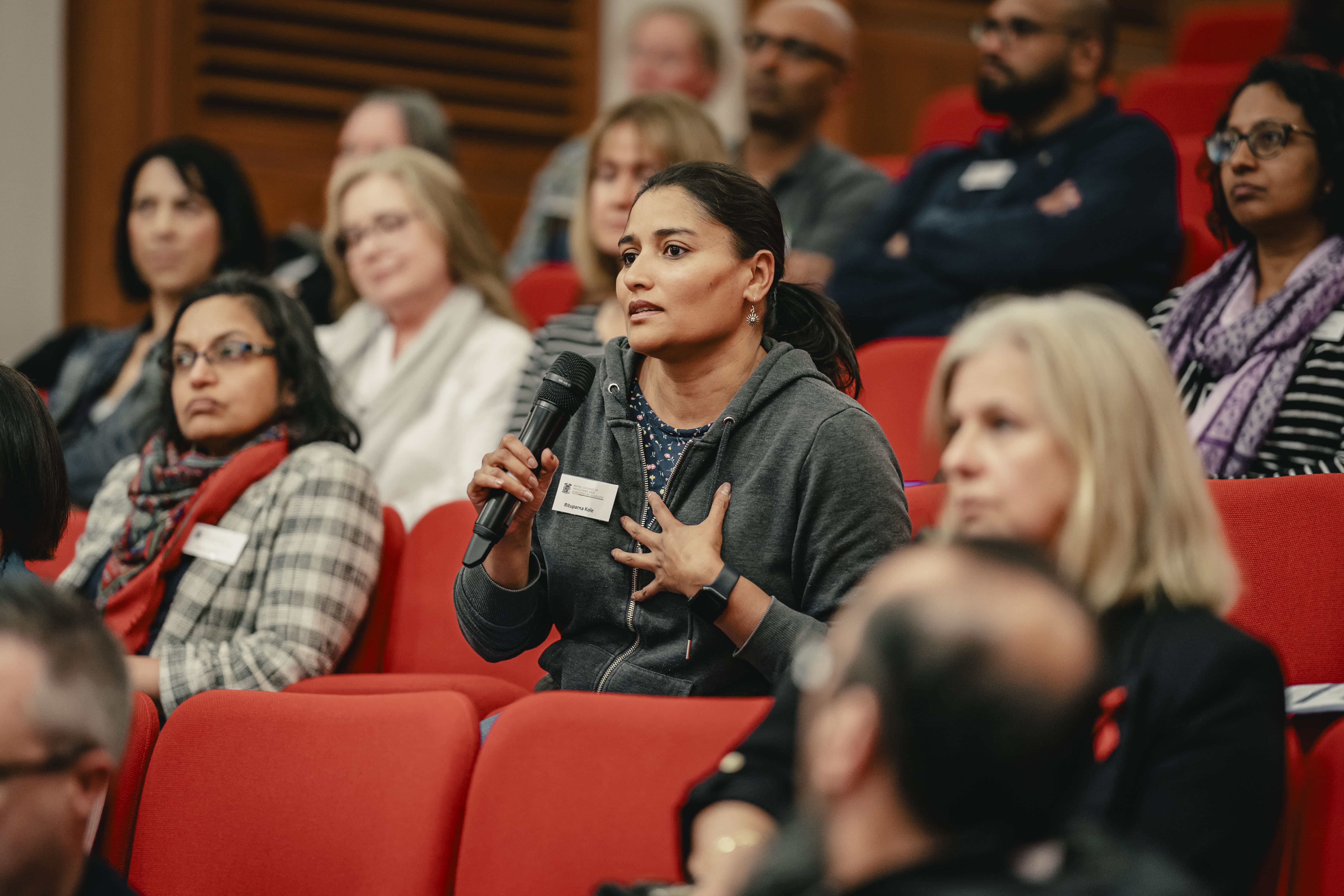 A woman talking into a mic at an SAS conference
