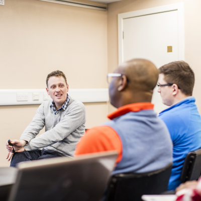Three people laughing and smiling