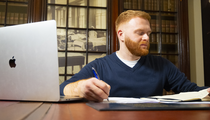 image of a man studying in a library