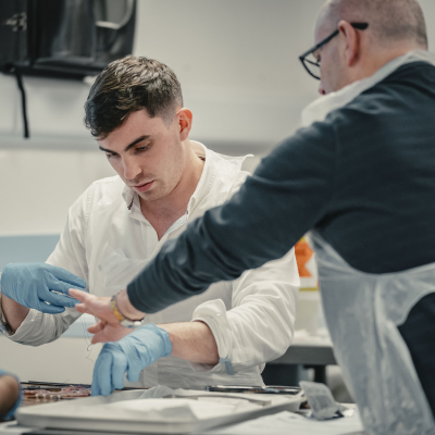 two people discussing practice at basic surgical skills