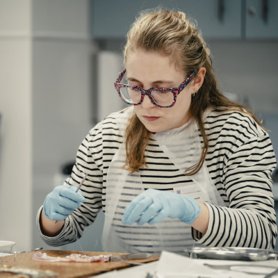 a woman doing practical basic surgical skills