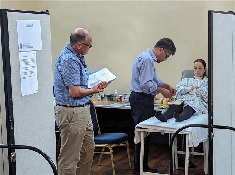 examiner examining a candidate during osce