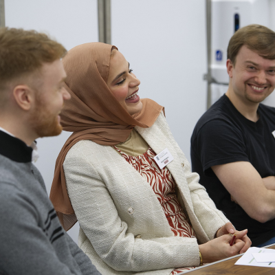 Three people laughing and smiling