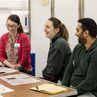 Three people laughing and smiling