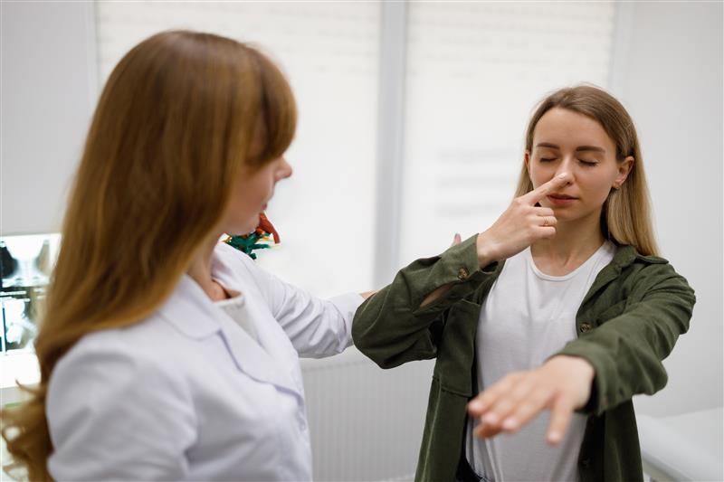 a doctor doing a nose tap test on a patient