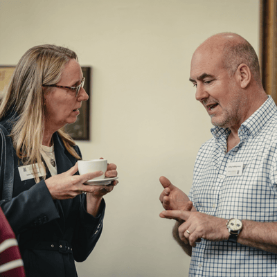 two people talking over a cup of tea