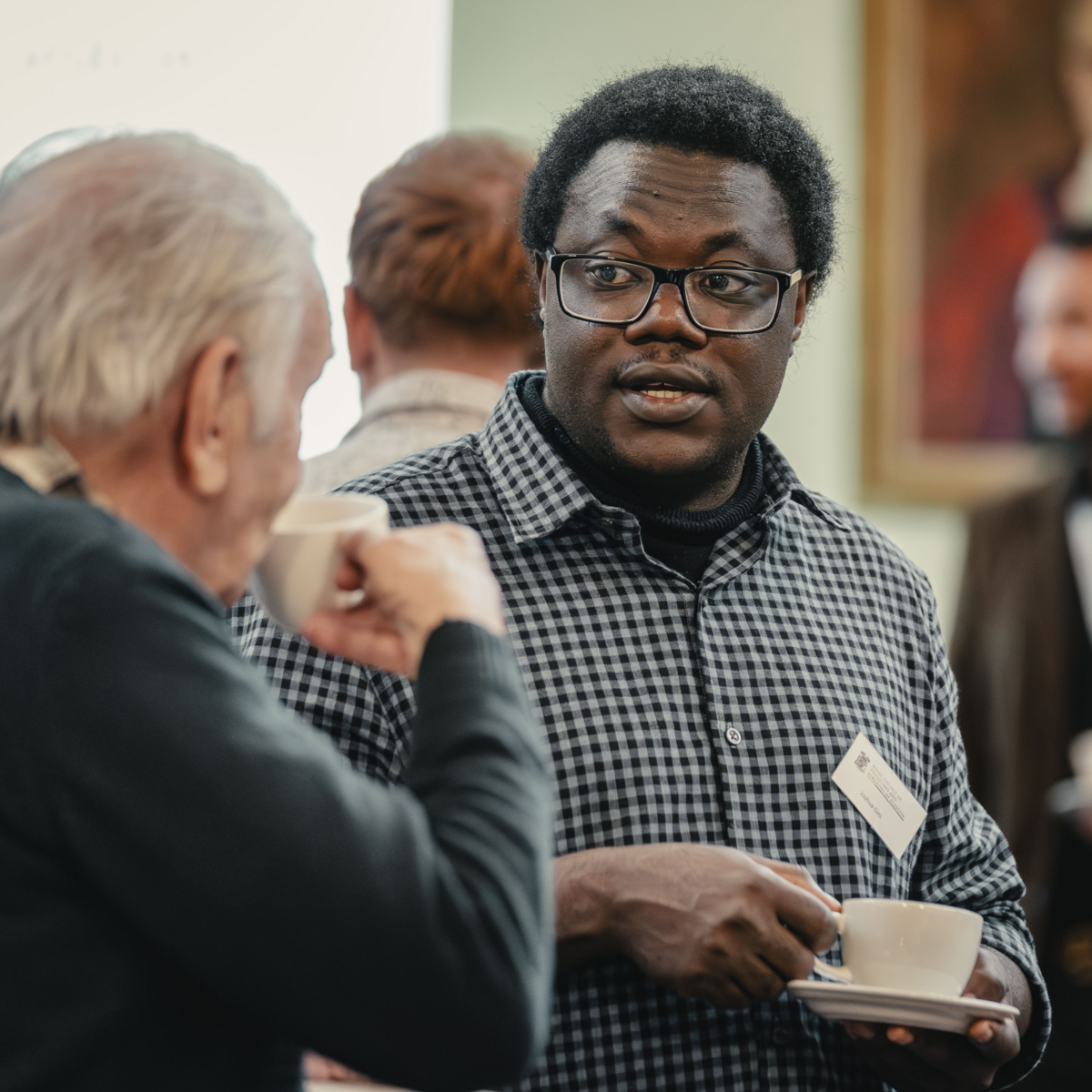People having a conversation and drinking tea