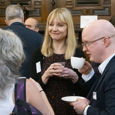 People conversing over tea