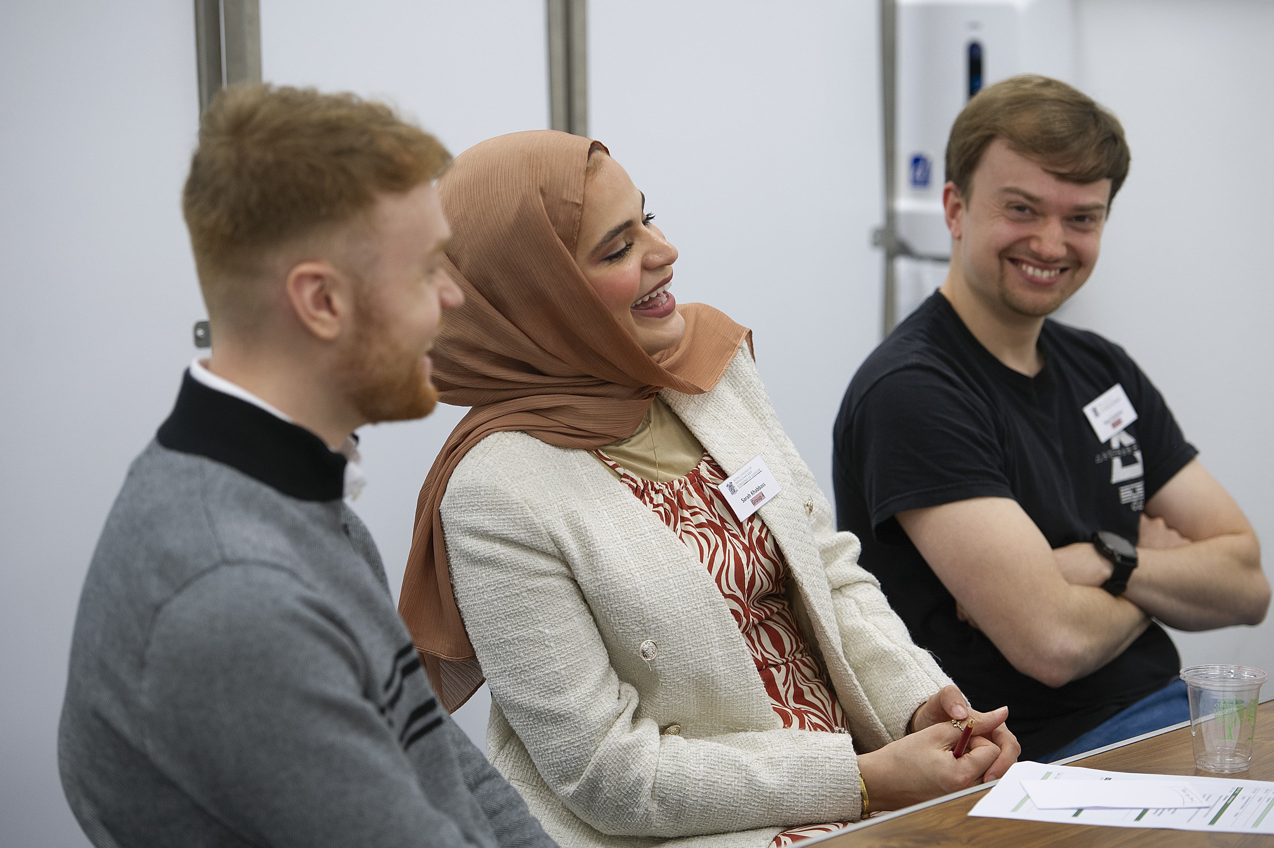 Three people laughing and smiling
