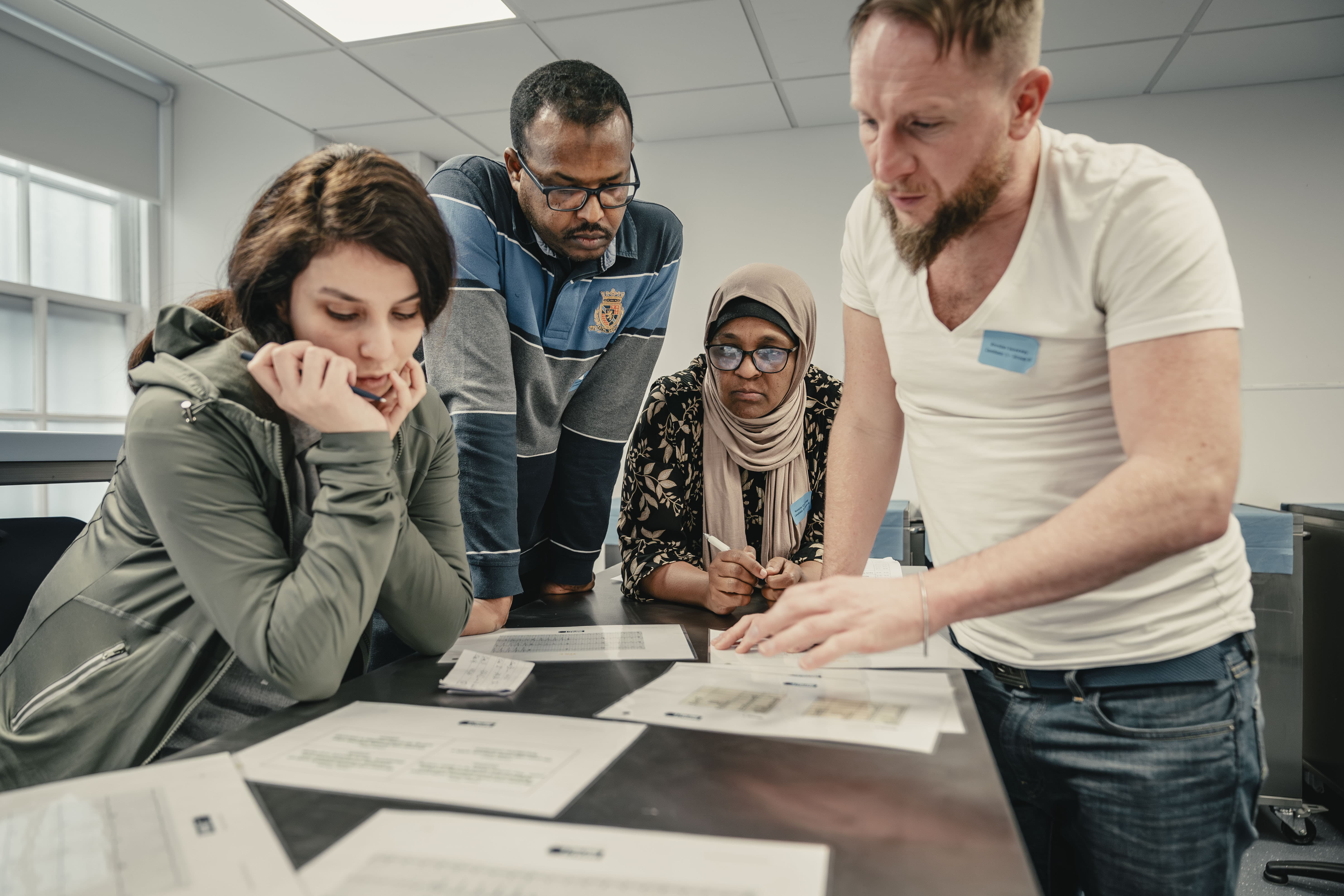 A group of healthcare professionals gather to look at the survey