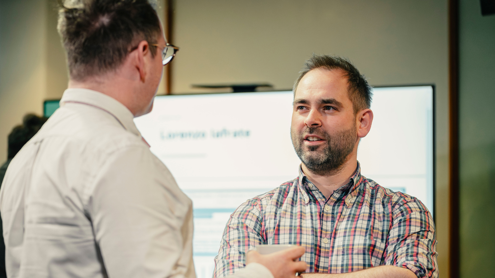 Men discussing at a conference